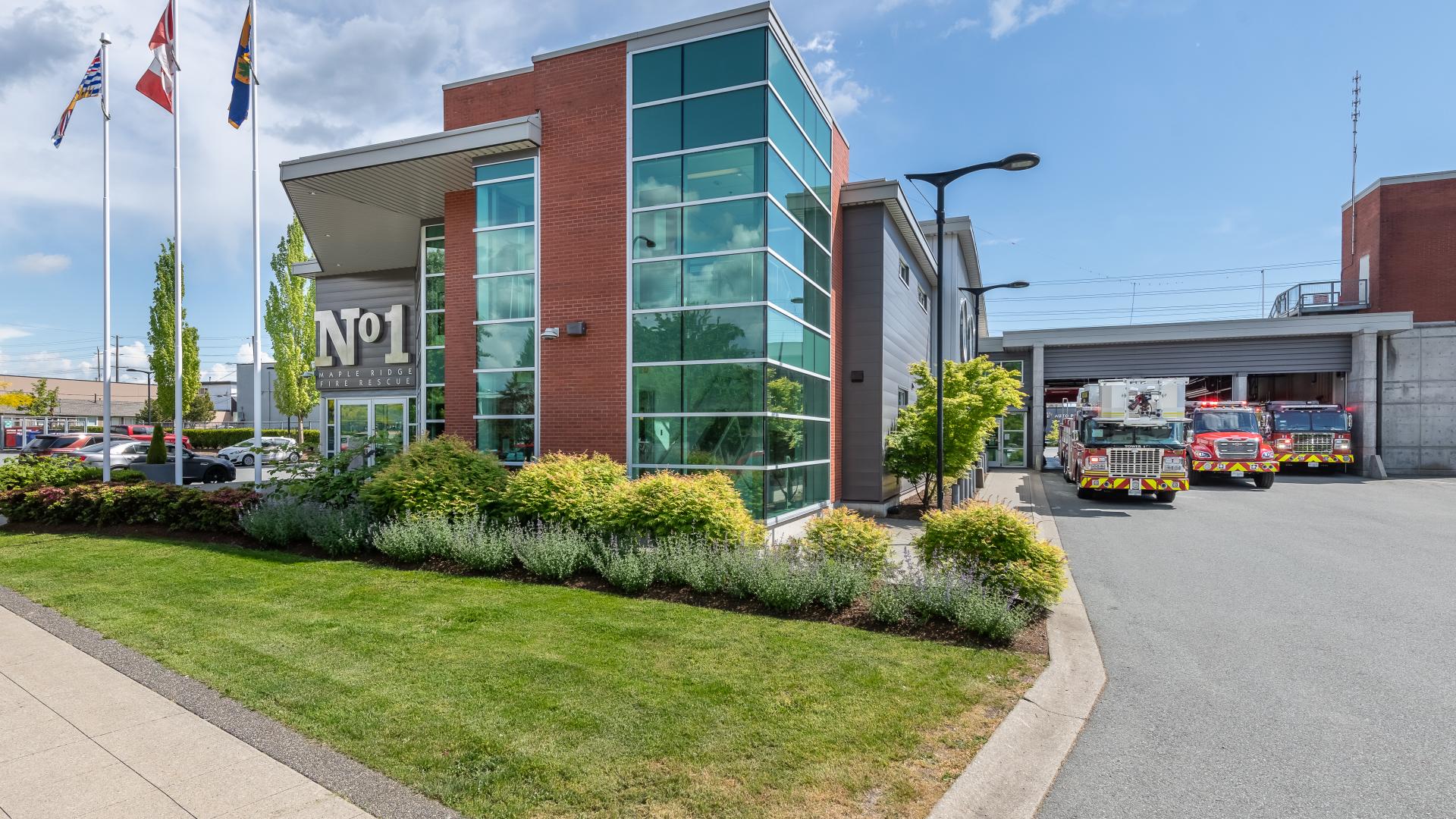 A large brick building with reflective windows houses Fire Hall number 1 and its fire engines.
