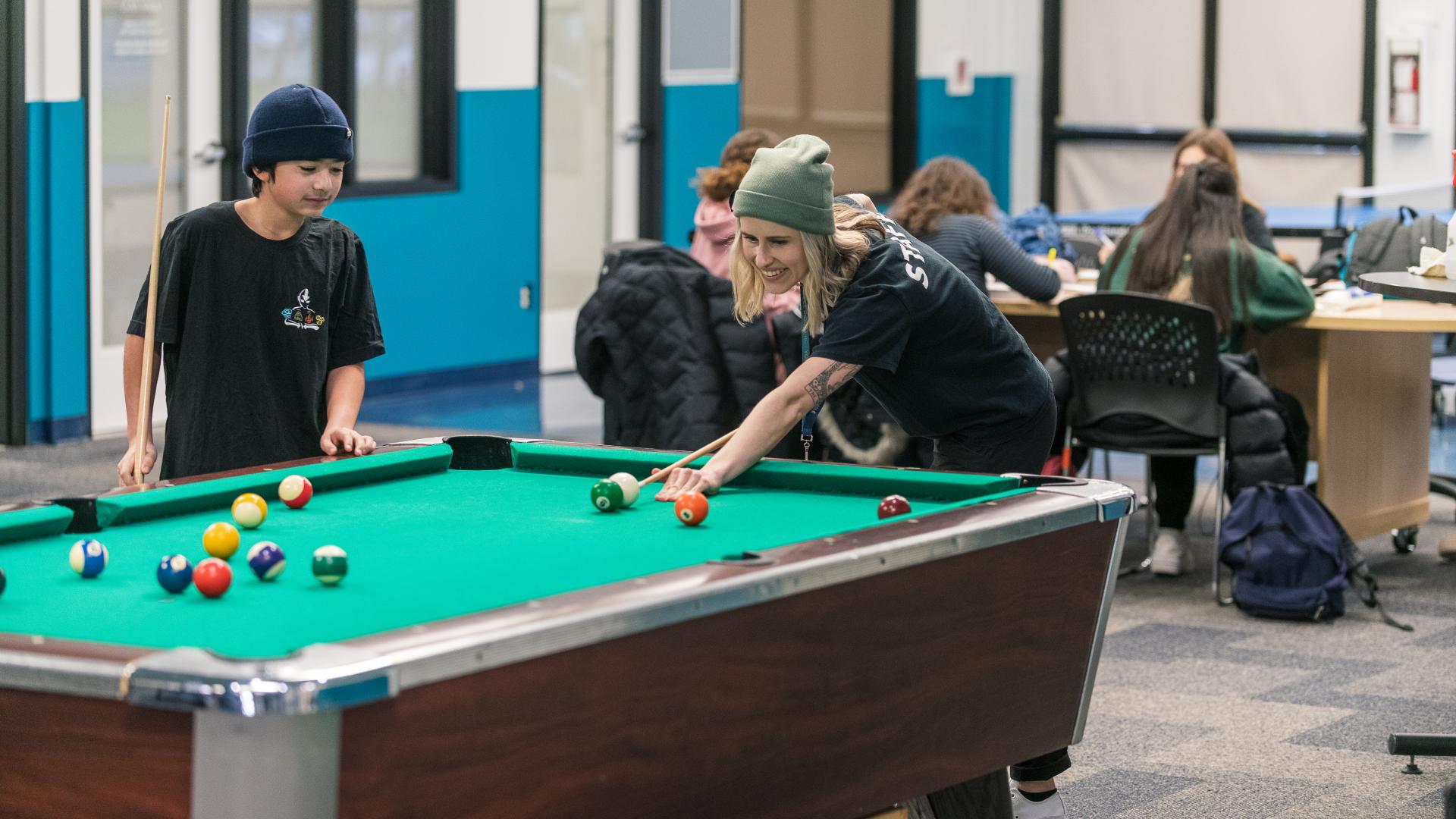 Staff and Youth Playing Pool at Greg Moore Youth Centre