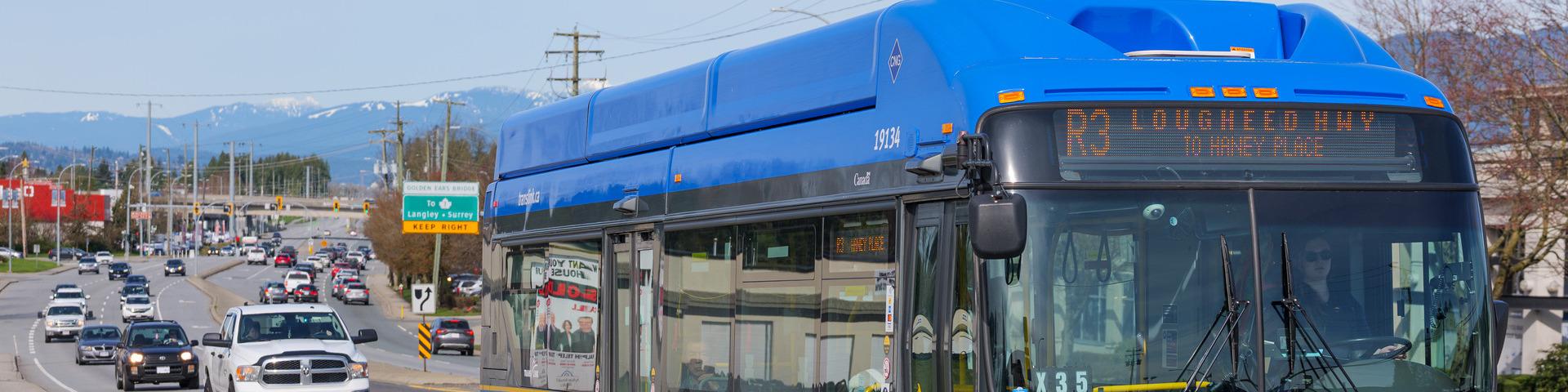 A Translink rapid bus travels down Lougheed Highway towards the Haney Place bus loop.