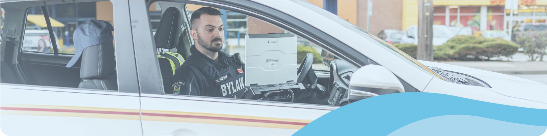 bylaw enforcement officer in a car