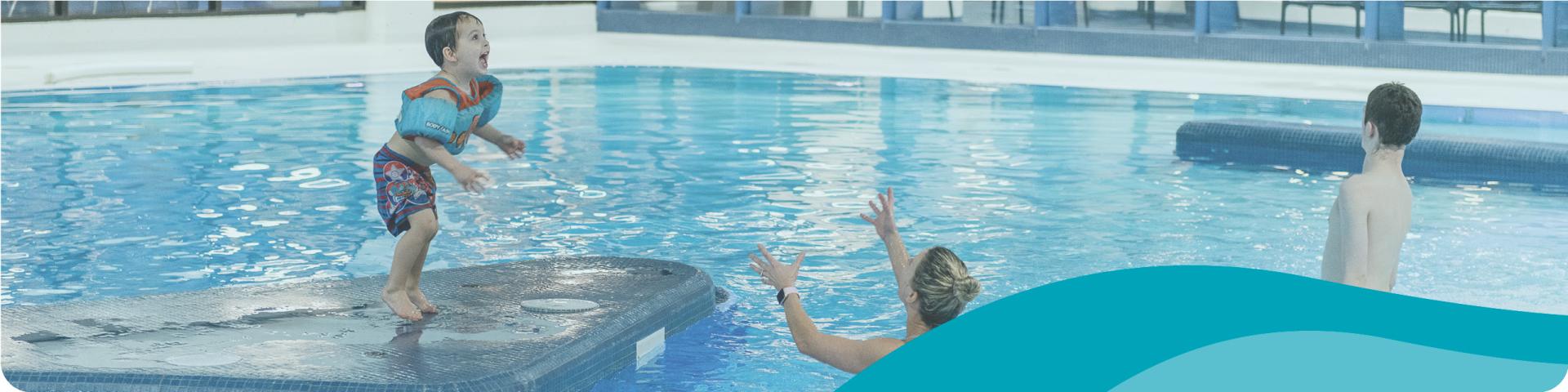 family playing in a pool