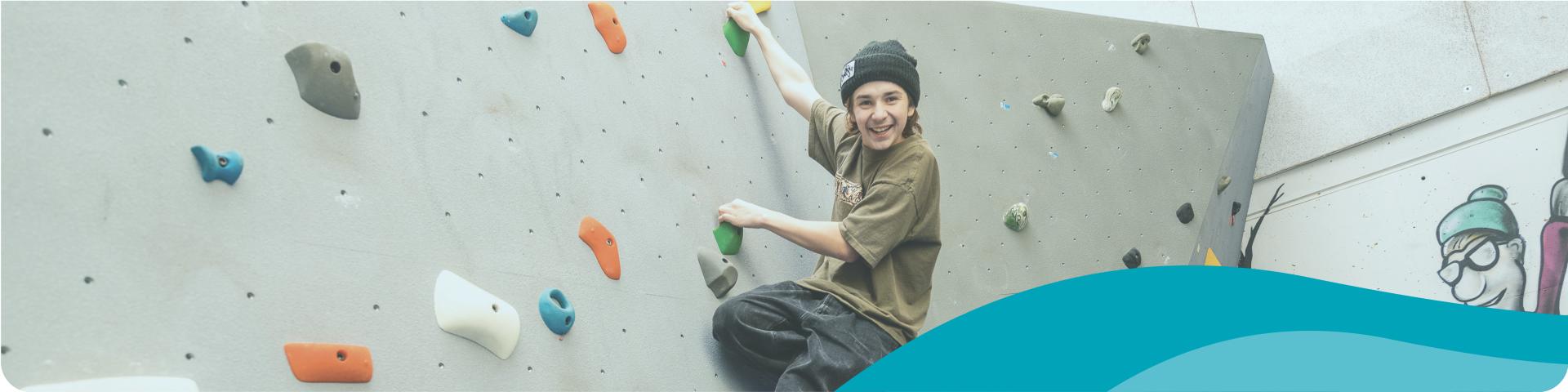 youth climbing the rock wall
