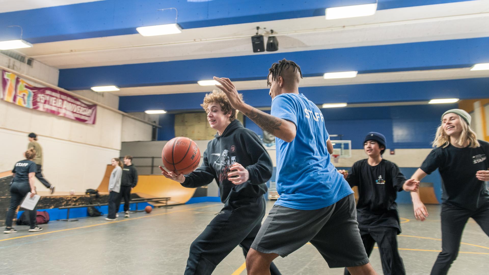 Group of Youth and Staff Playing Basketball at Greg Moore Youth Centre