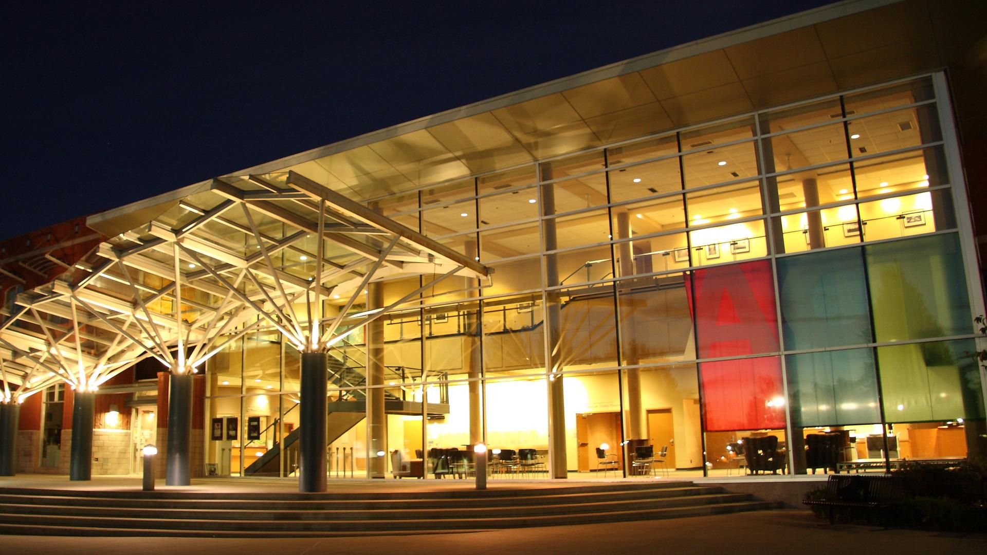 The ACT theatre lit up brightly at night.