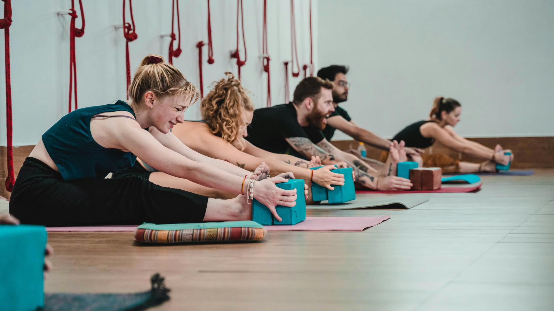 Group of People Stretching in Fitness Class