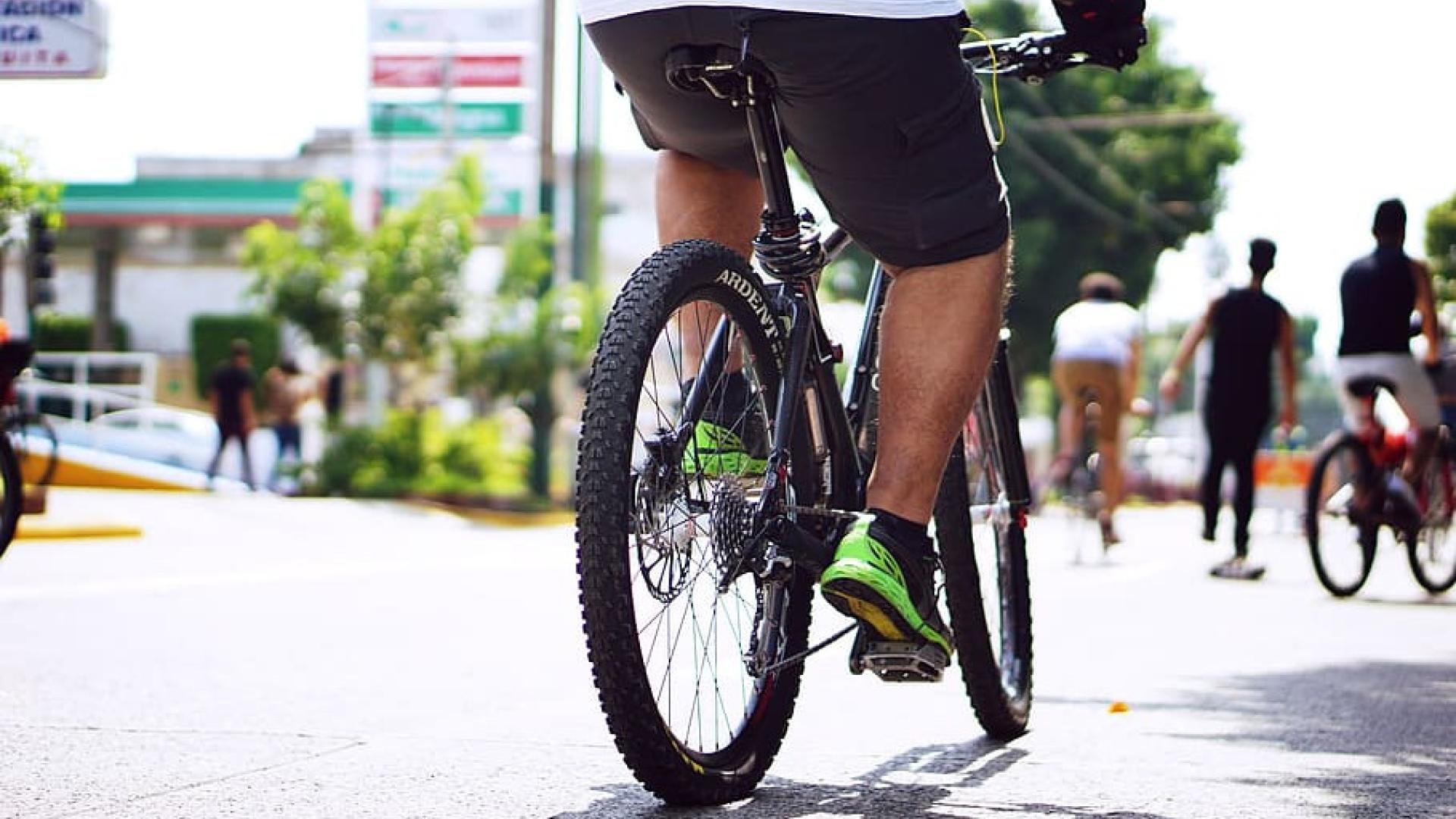 A person bicycles down a busy city street.