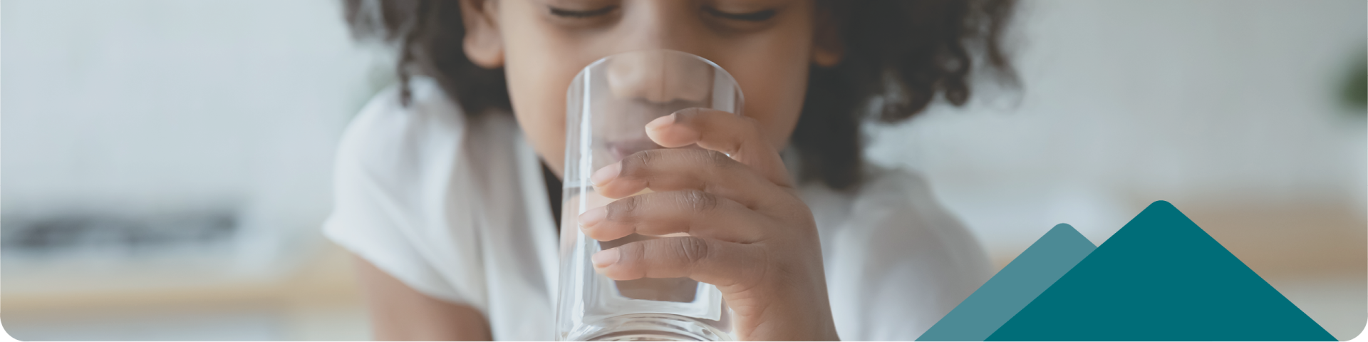 kid drinking a glass of water