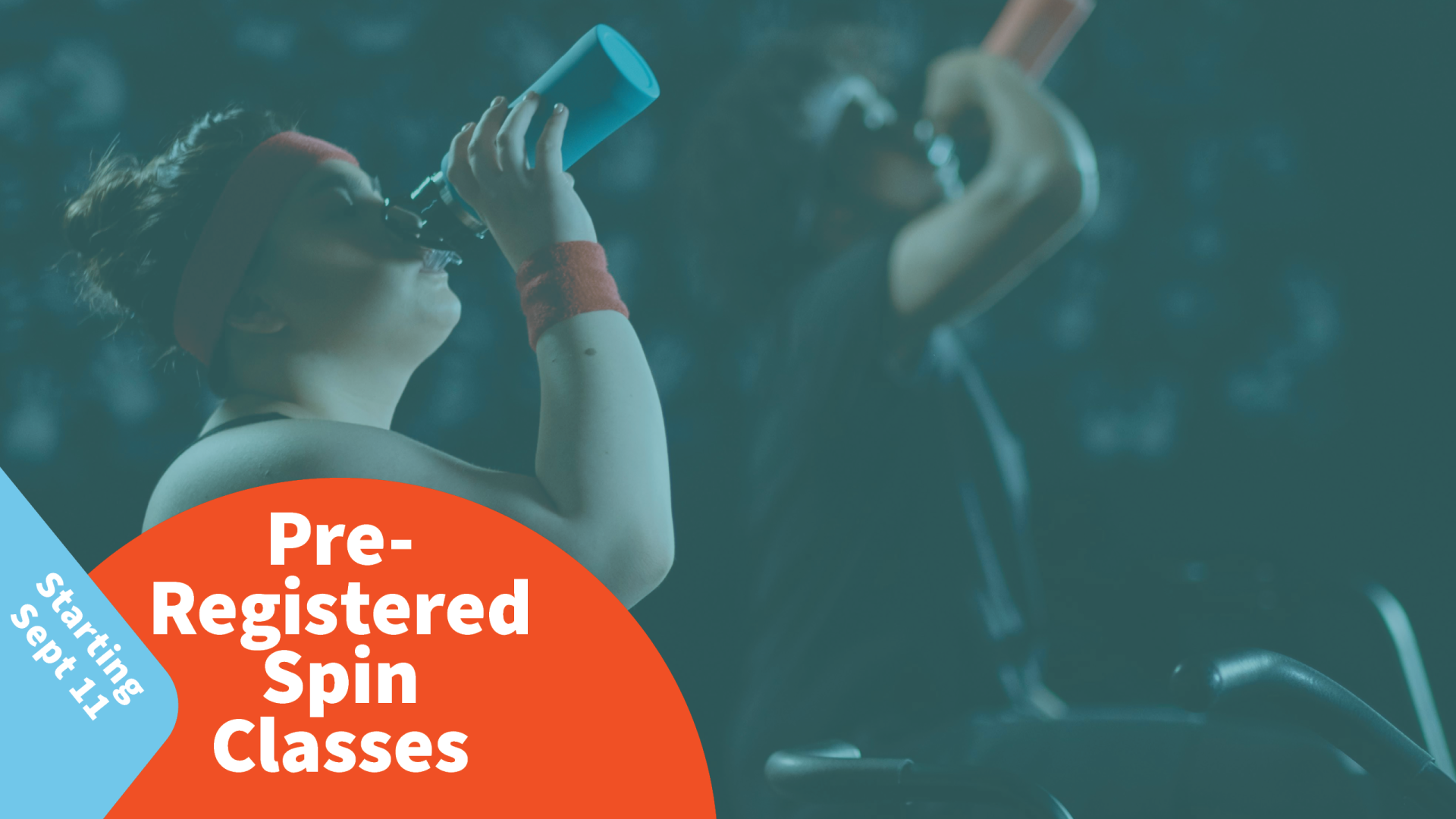 Two people on their spin bikes drinking water